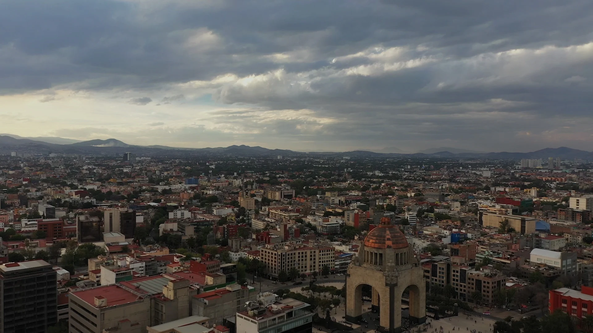 Video montage of cities and faces across the globe.