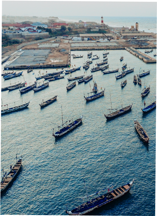 A scene of boats sitting on the water at dawn.