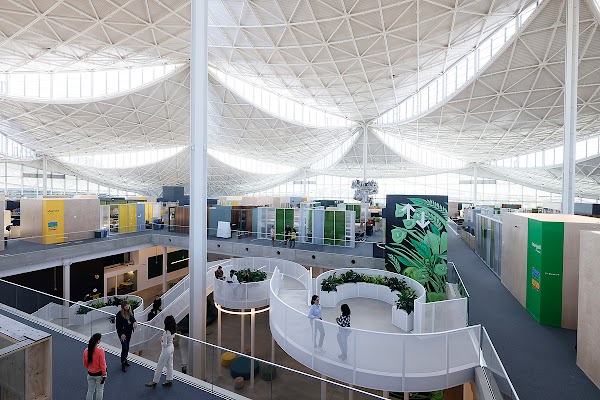 Interior photo of Googlers talking with each other in the hallway, and on the “Mothership Stairs” at Bay View.