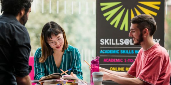 Library staff helping students with their studies.