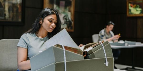 Someone reading an old book on a stand