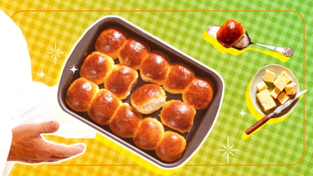 A person presenting dinner rolls in a casserole dish on a green background.