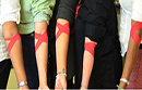 People with bandaged arms following giving blood