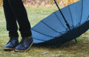 Feet next to dropped umbrella