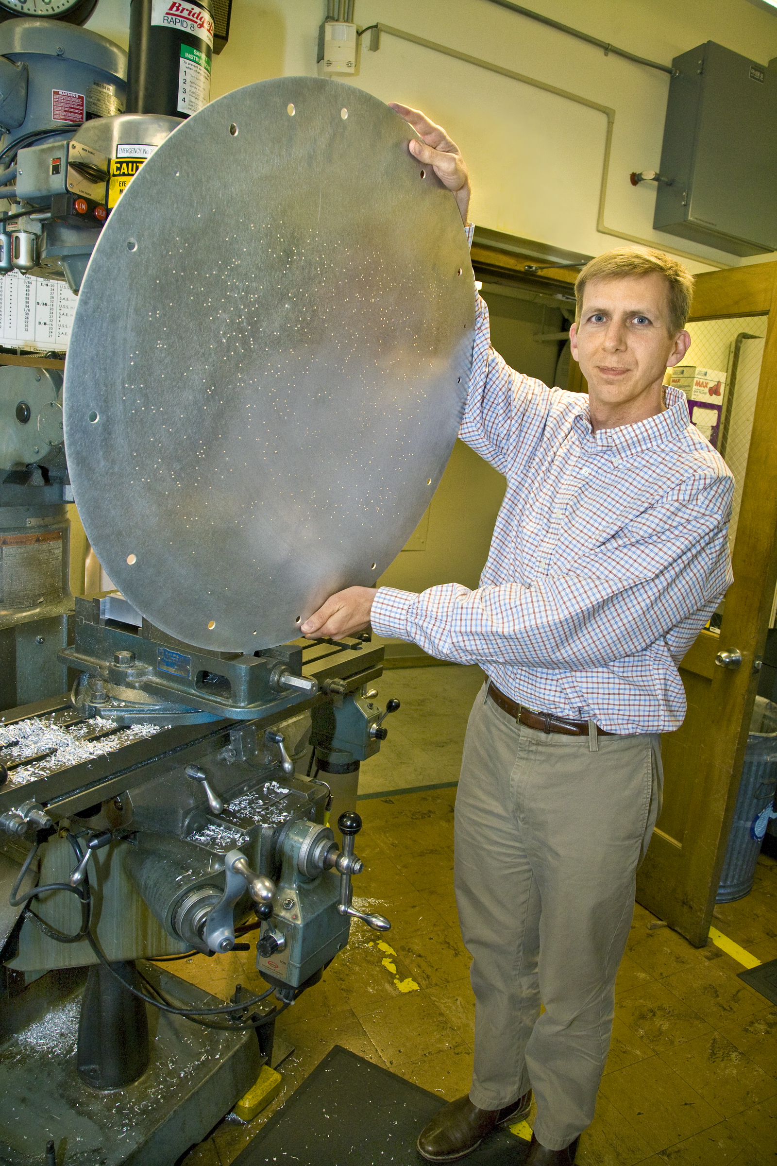 David Schelegel, PI of BOSS, shows off a plug plate. Image credit: LBL