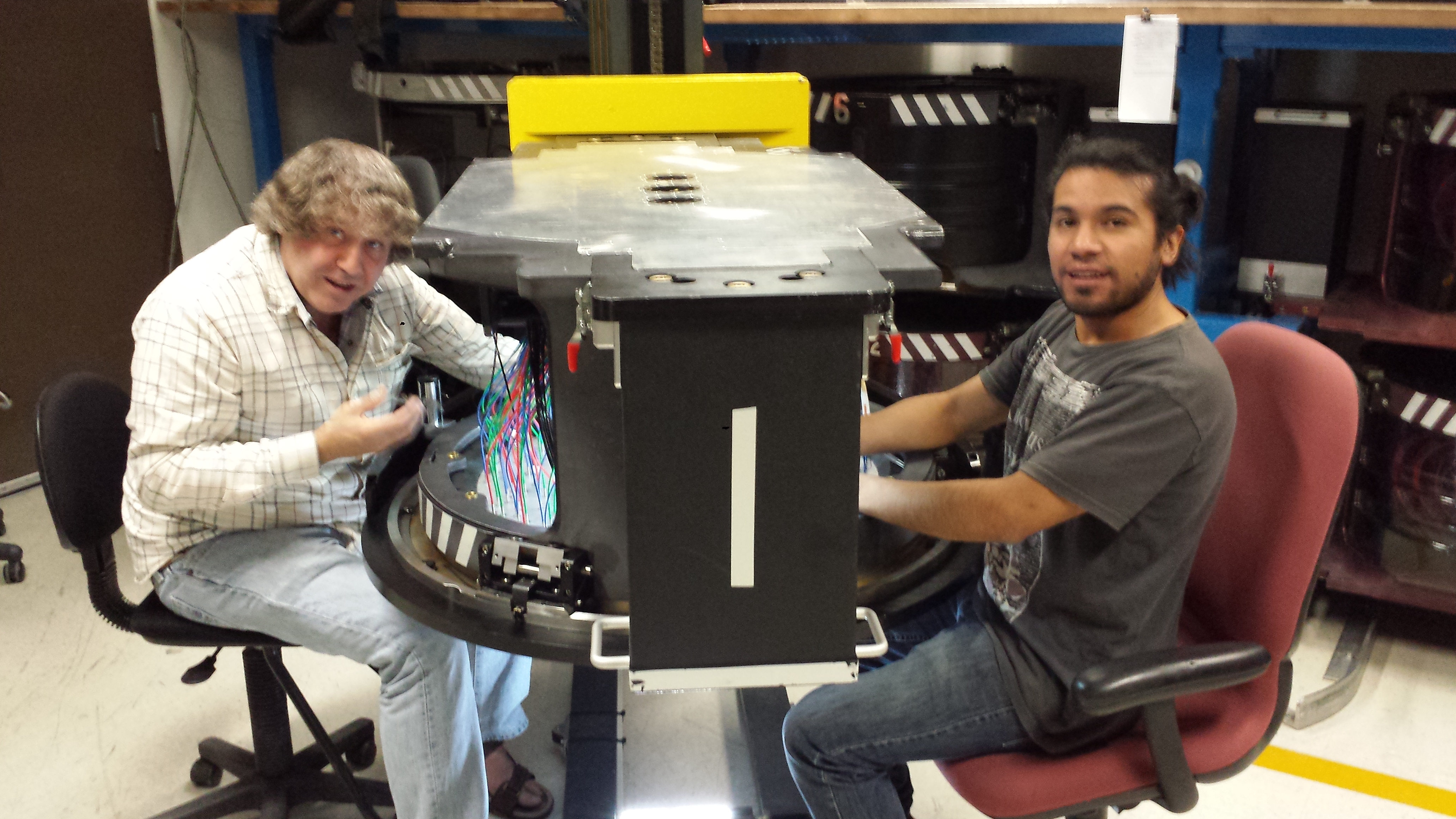 Christian and Jamie seen here plugging fibers into a plug plate. Christian y Jaime se ven aquí conectando las fibras en una placa de conexión.