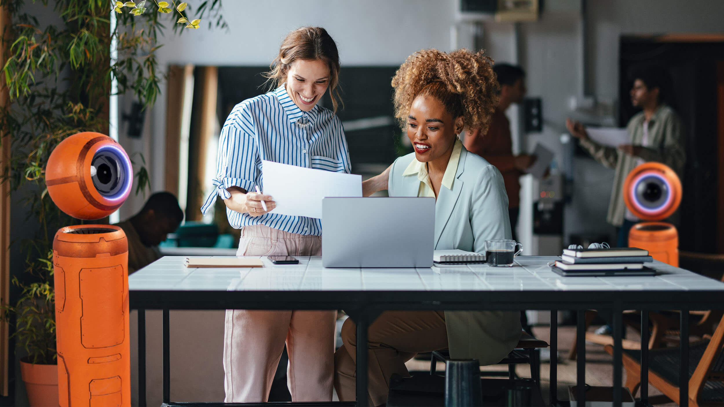 Women at desk with ii robots