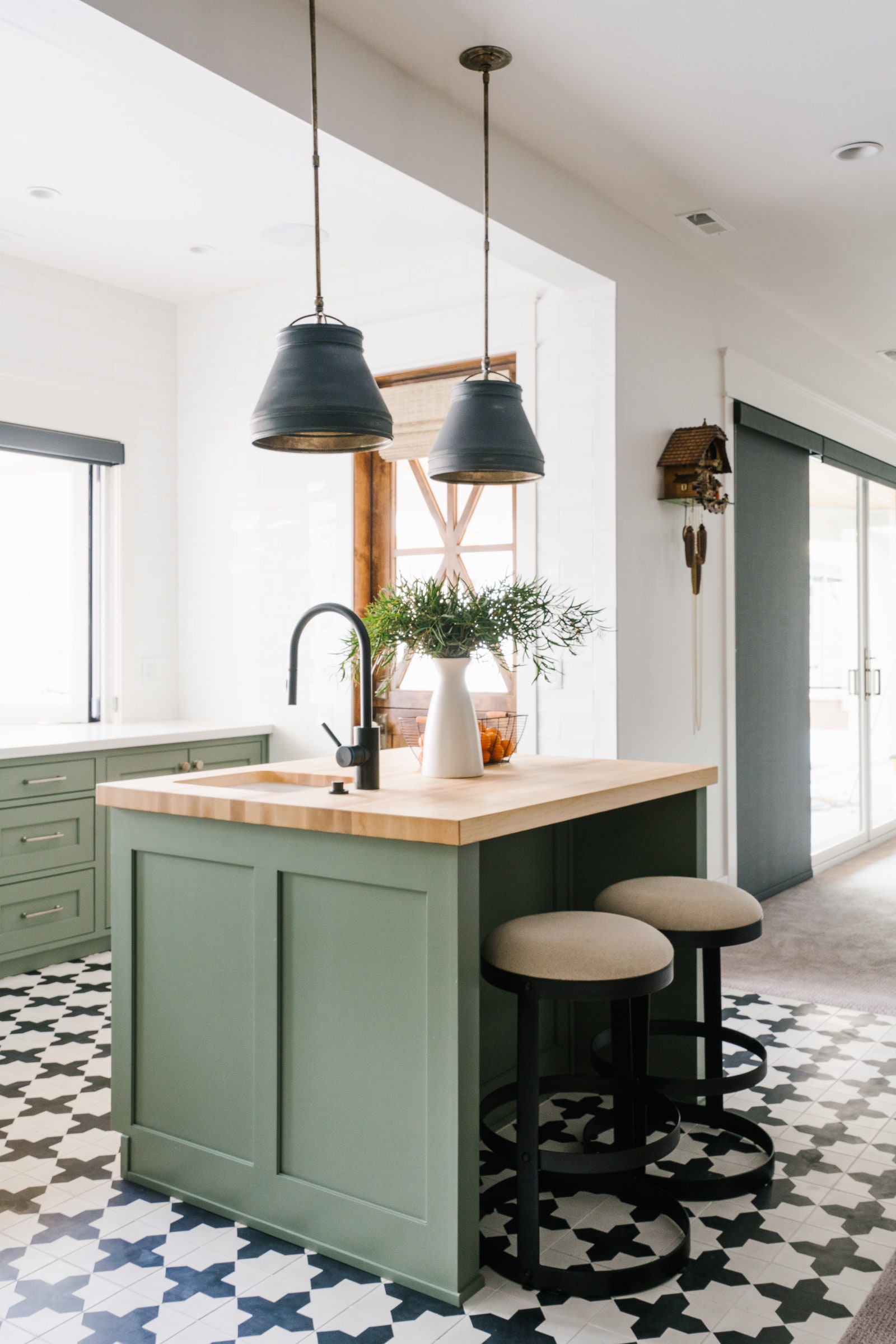 Modern farmhouse kitchen green island black and white tiled floors