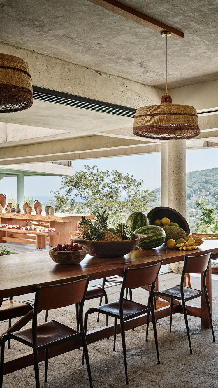 Handwoven pendant lights by Sara Efia Reddin hang above vintage French Mullca school chairs in the family kitchen.