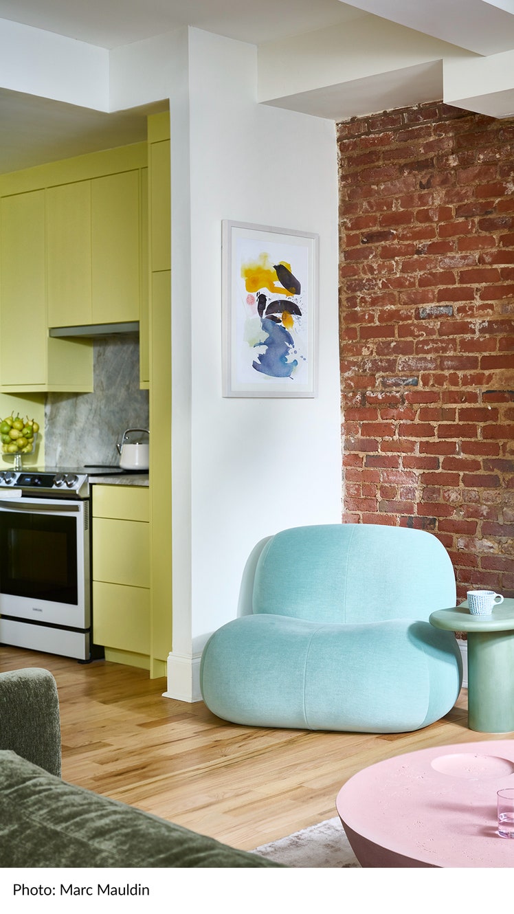 Living room designed by Leah Alexander of Beauty Is Abundant design with a light blue accent chair pink table green...