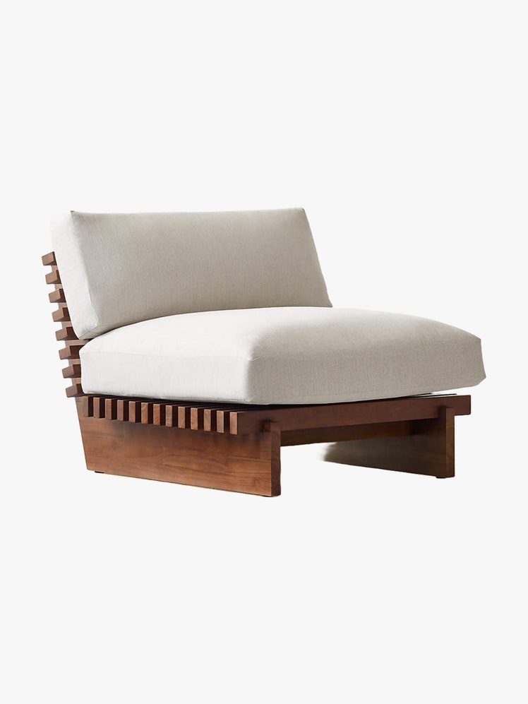 Lowslung and appealingly boxy outdoor lounge chair with teak frame and removable beige cushions.