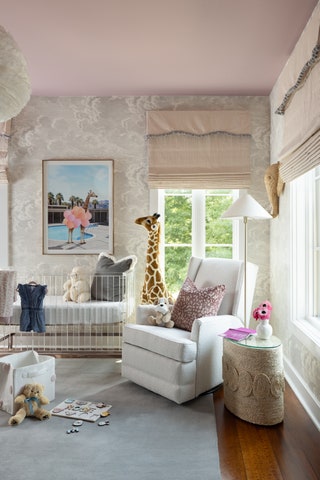 baby girl nursery with pink ceiling beige roman shades over two windows abstract grayandwhite wallpaper dark hardwood...