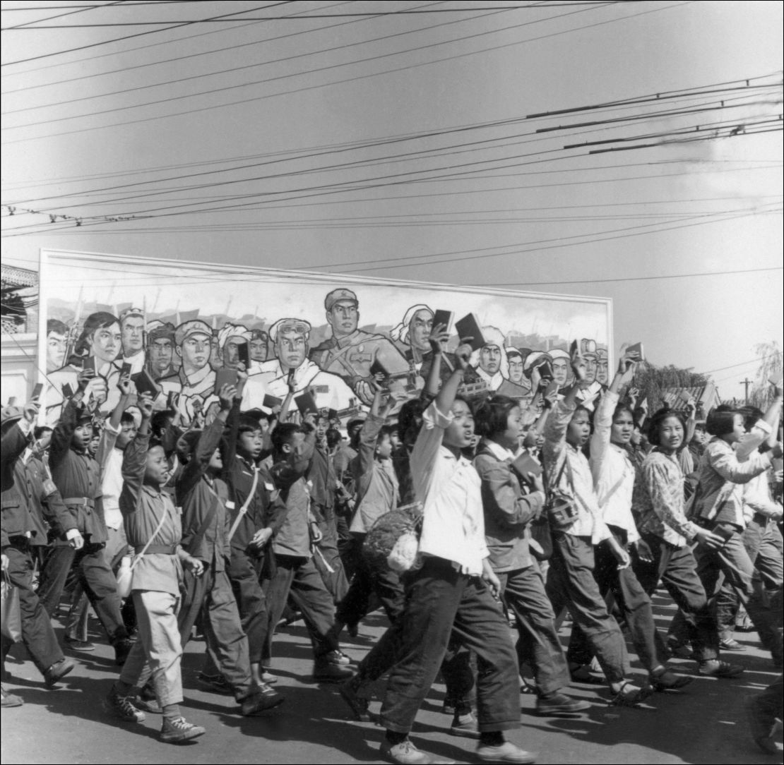 Red Guards, high school and university students, waving copies of Chairman Mao Zedong's "Little Red Book," parade in June 1966 in  Beijing's streets during the Cultural Revolution.