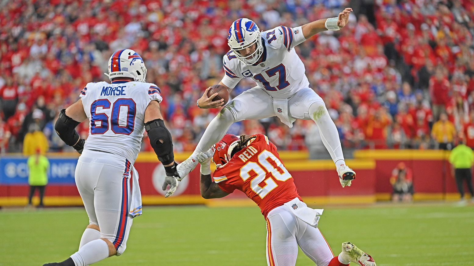 Buffalo Bills quarterback Josh Allen hurdles Kansas City Chiefs safety Justin Reid as he scrambles for a first down. Allen's fourth quarter touchdown throw to Dawson Knox capped off a 24-20 victory against the Chiefs. 