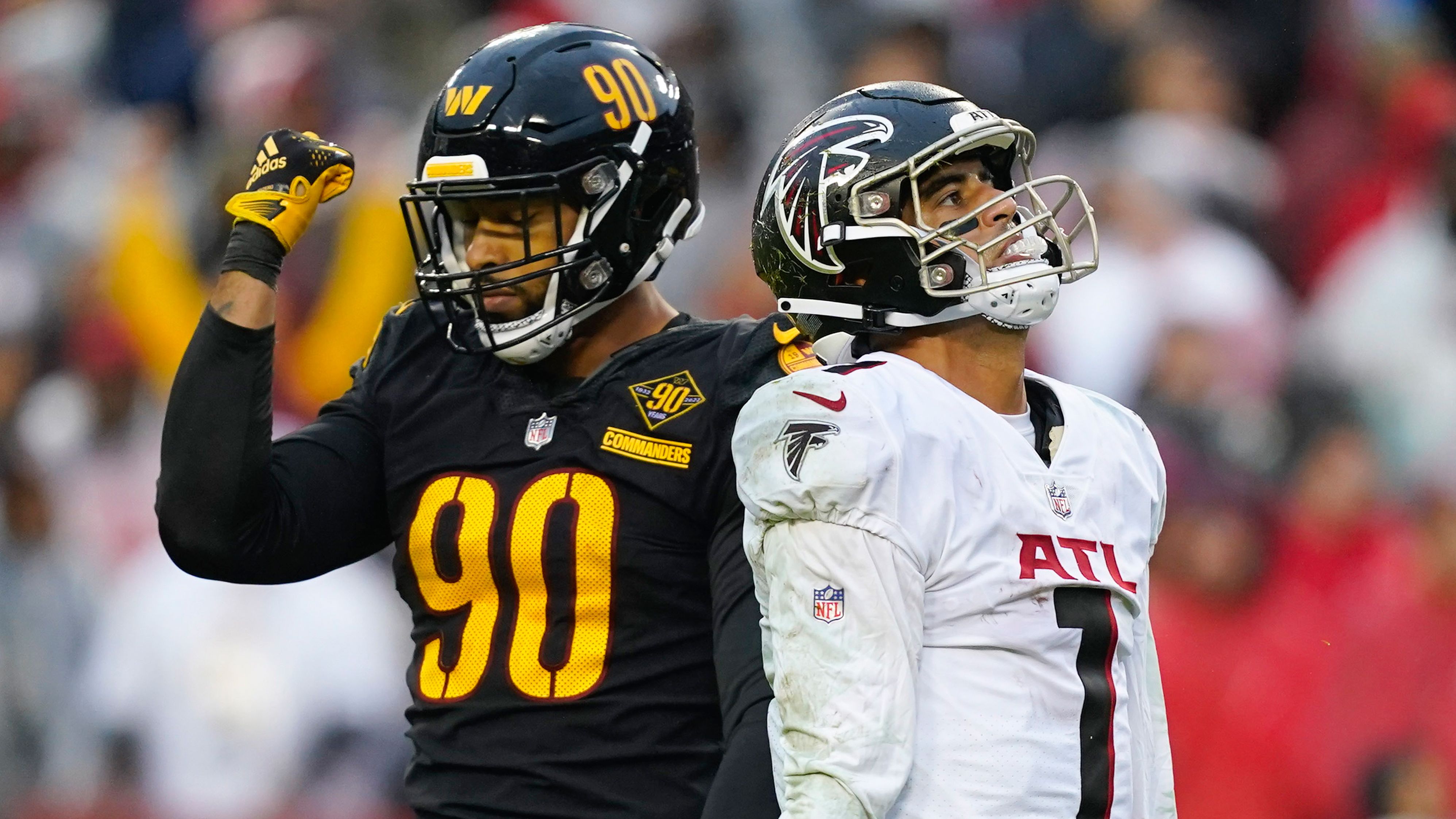 Two sides of the coin... Atlanta Falcons quarterback Marcus Mariota and Washington Commanders defensive end Montez Sweat react to Mariota's second half interception on November 27. Washington won the game 19-13.