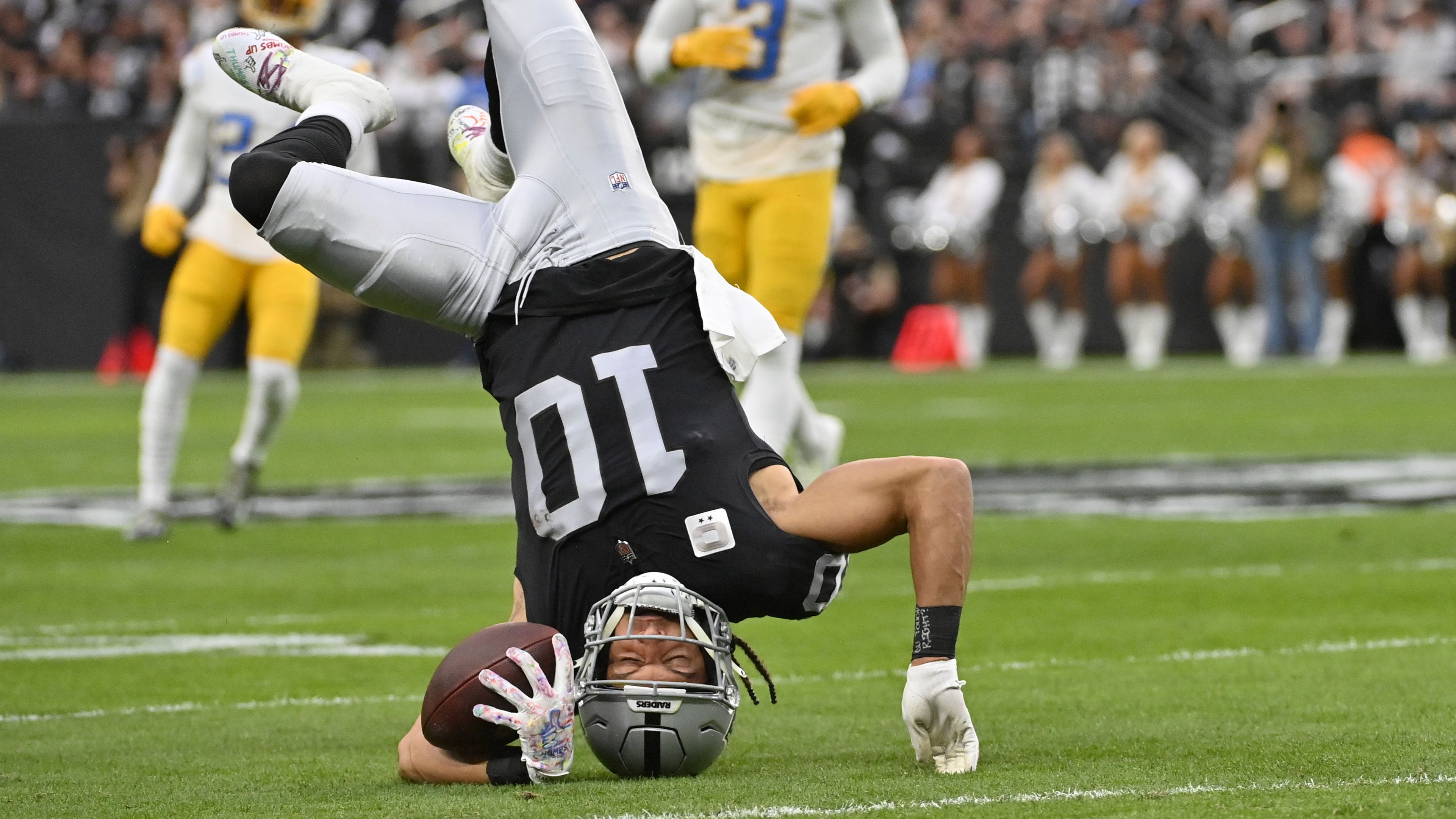 Las Vegas Raiders wide receiver Mack Hollins goes upside down on a reception during the first half against the Los Angeles Chargers. The Raiders eventually beat the Chargers 27-20, largely thanks to a monster afternoon for star wide receiver Davante Adams, who finished with 177 receiving yards and two touchdowns. 