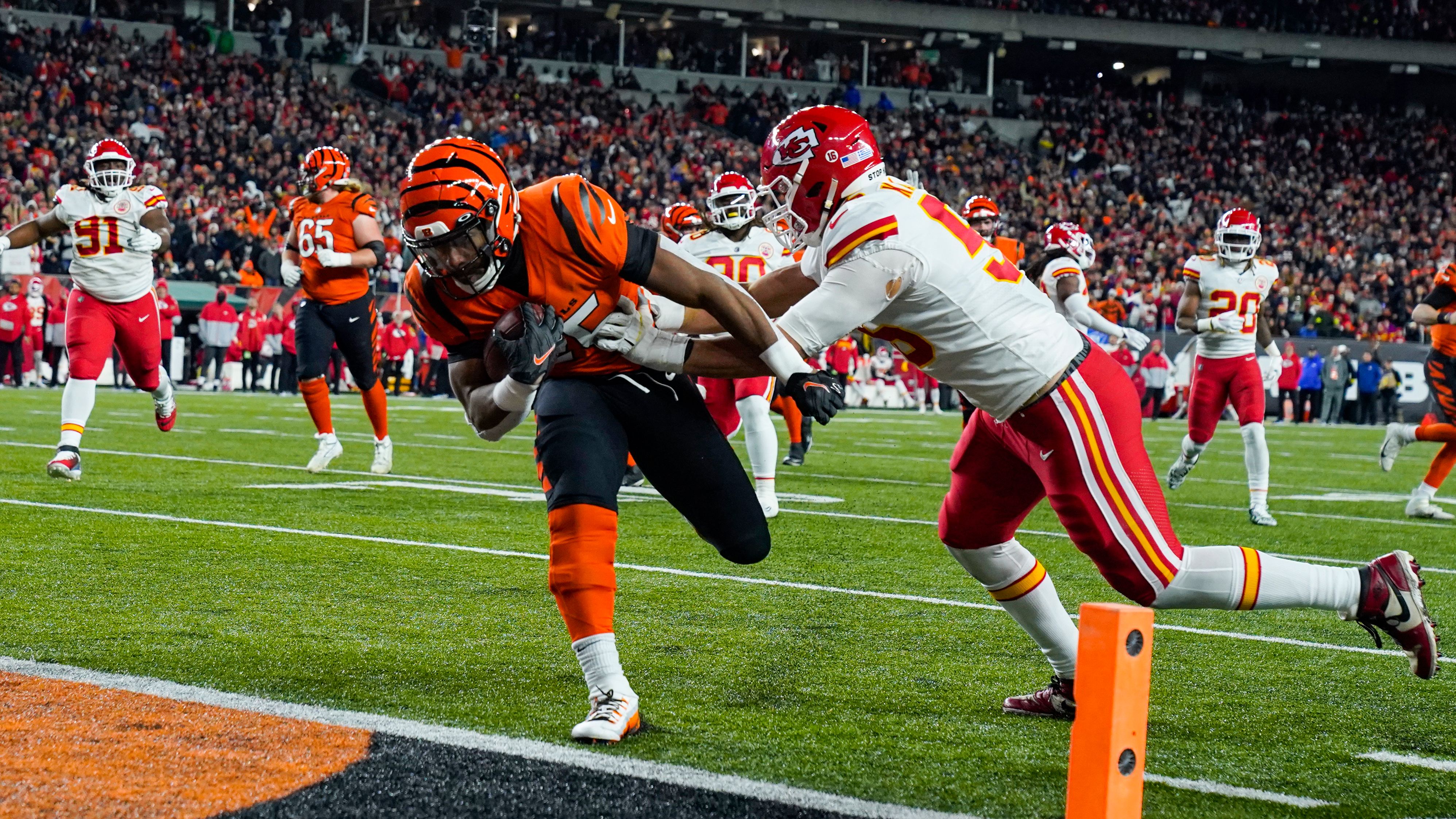 Cincinnati Bengals running back Chris Evans runs in for a touchdown past Kansas City Chiefs defensive end George Karlaftis in the second half. Behind two touchdown passes from Bengals quarterback Joe Burrow, Cincinnati beat the Chiefs 27-24.