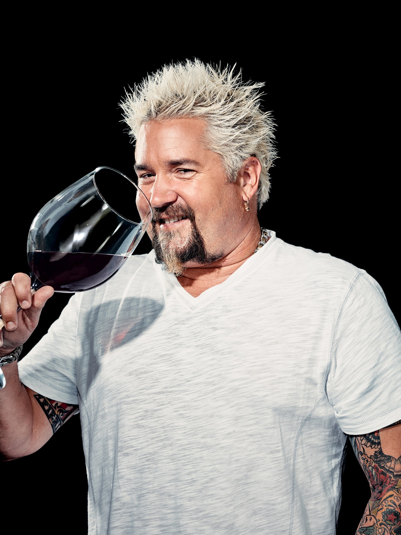 Image may contain Guy Fieri Sunglasses Accessories Accessory Human Person Glass Skin Drink Beverage and Alcohol