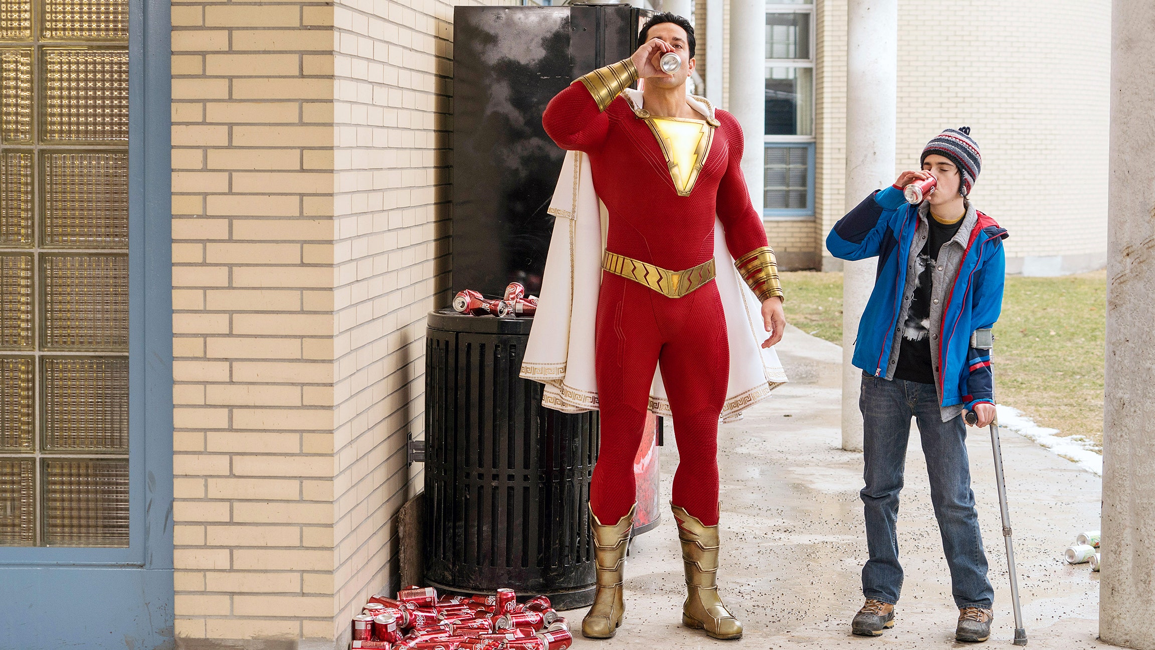 film still of boy and superhero crushing soda