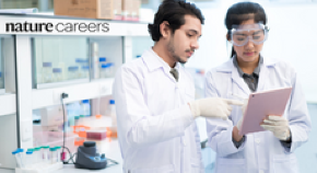 Two scientists looking at a clipboard