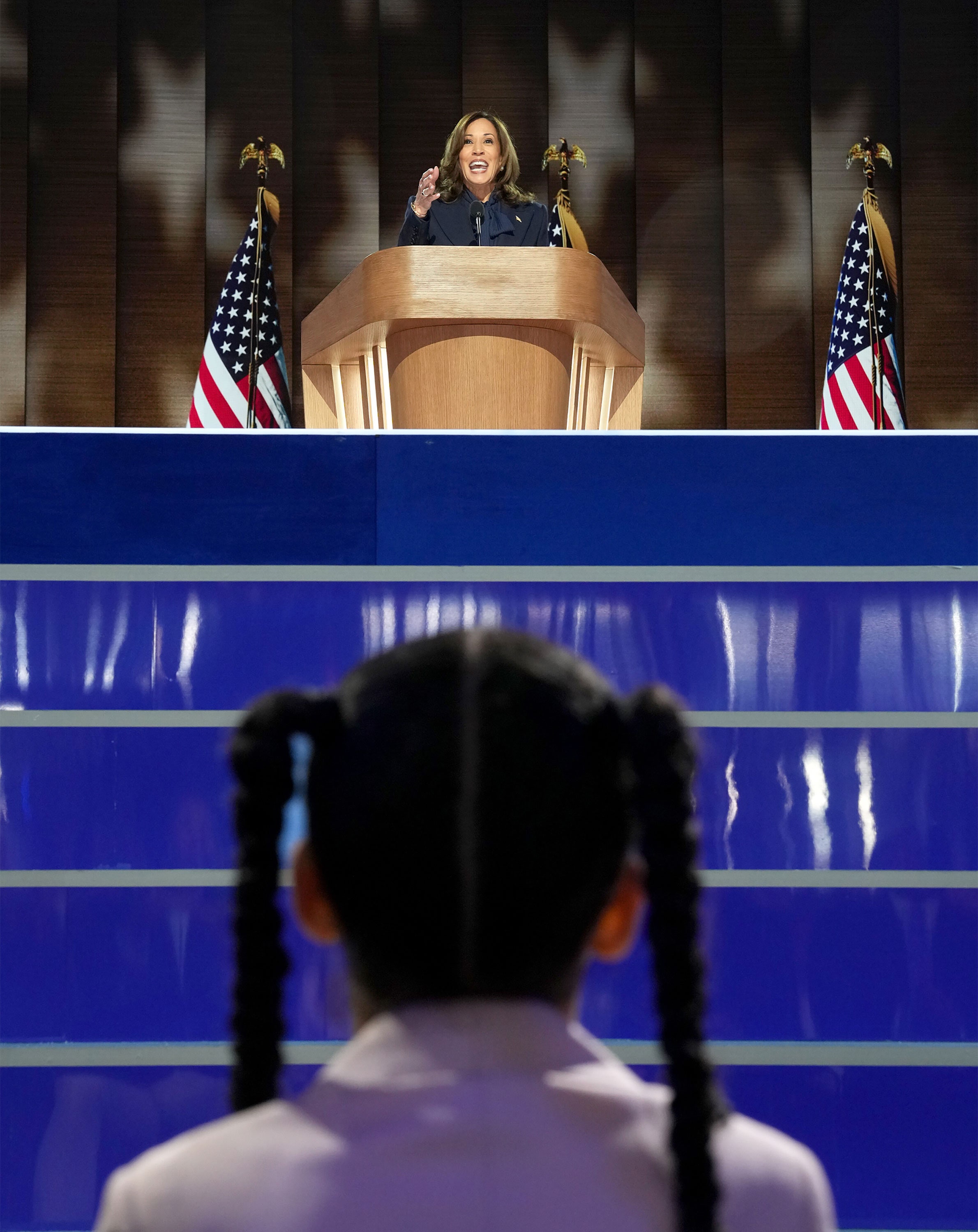 Image may contain Kamala Harris Crowd Person Flag Adult Audience Speech Electrical Device Microphone and Podium