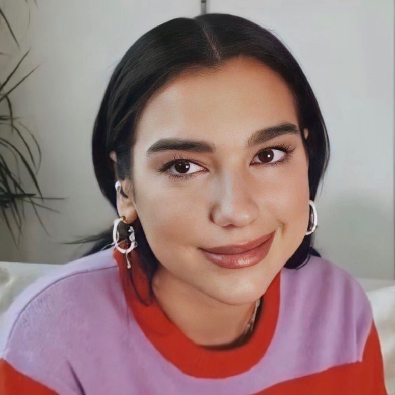 Image may contain: Dua Lipa, Face, Human, Person, Smile, Cushion, and Pillow