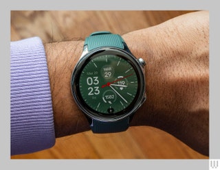 Overhead view of the OnePlus Watch 2 wristwatch with a green band on a wrist.