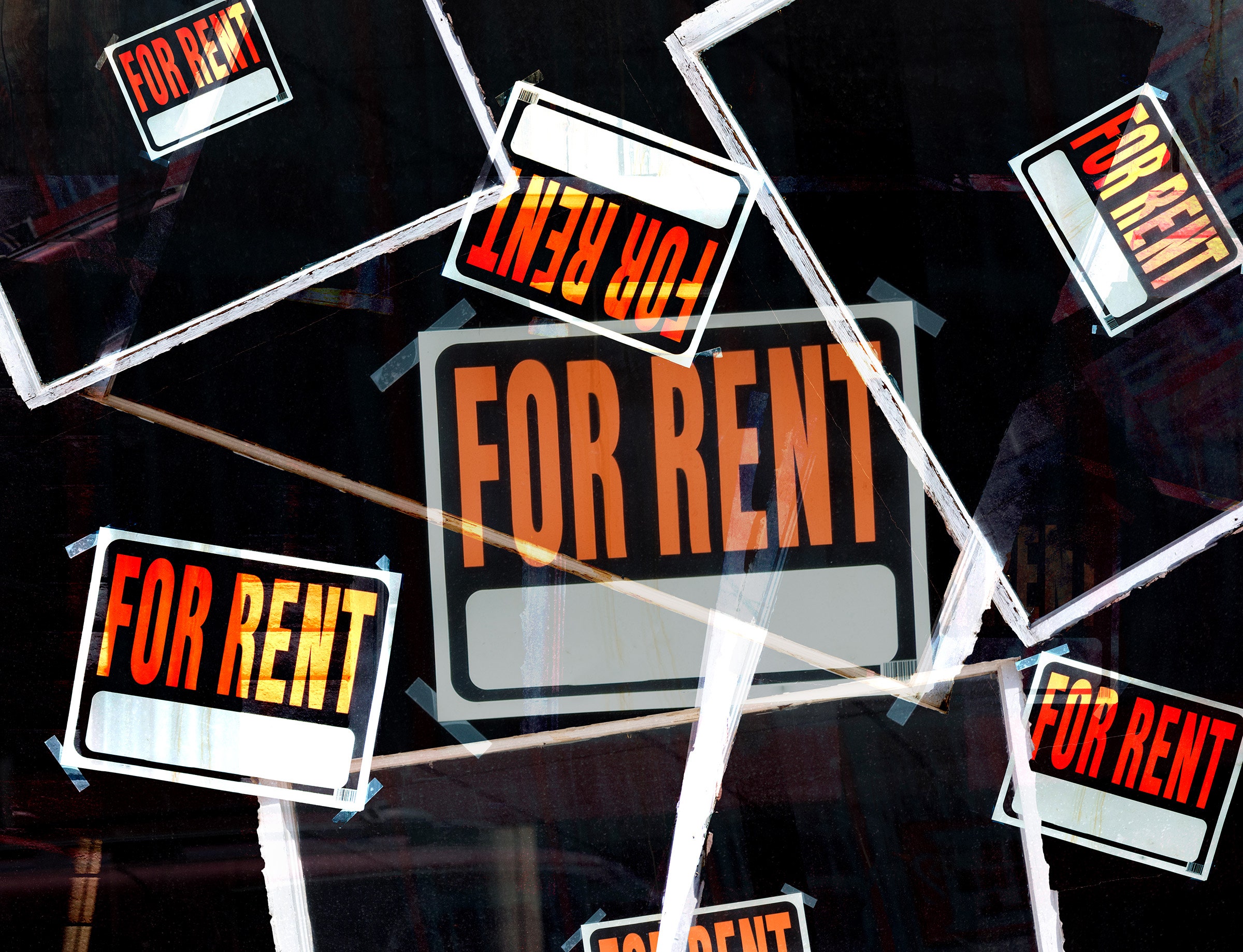 Layers of orange and black FOR RENT signs