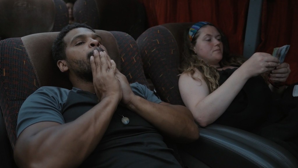 Celebrity Race Across The World star Kola Bokinni and cousin Mary Ellen reclining on a bus in South America
