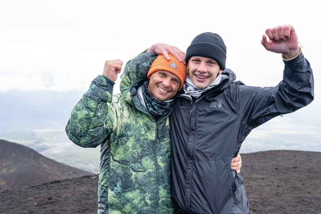 Celebrity Race Across The World Jeff Brazier and son Freddy with their arms around each other on a mountain
