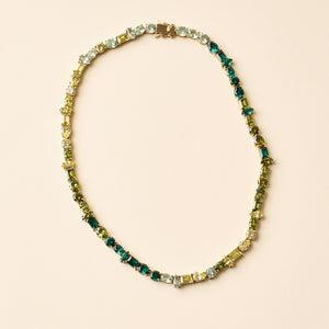 Green Multi Crystal Tennis Necklace On Tan Background