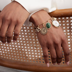 Stone, Gold, and Pearl Charm Bracelet Styled on Model's Wrist 