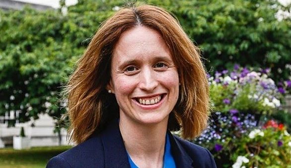 Head and shoulders shot of Eve Roodhouse, Chief Officer, Culture and Economy at Leeds City Council. She is stood outside in front of some trees and is smiling to camera