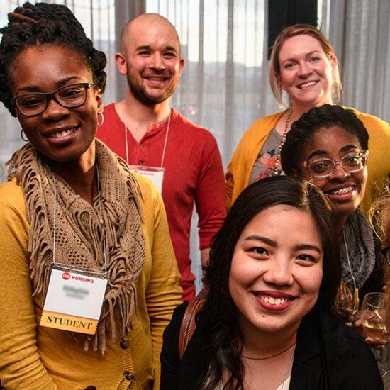 A group of young people representing multiple ethnicities and genders smile at the camera