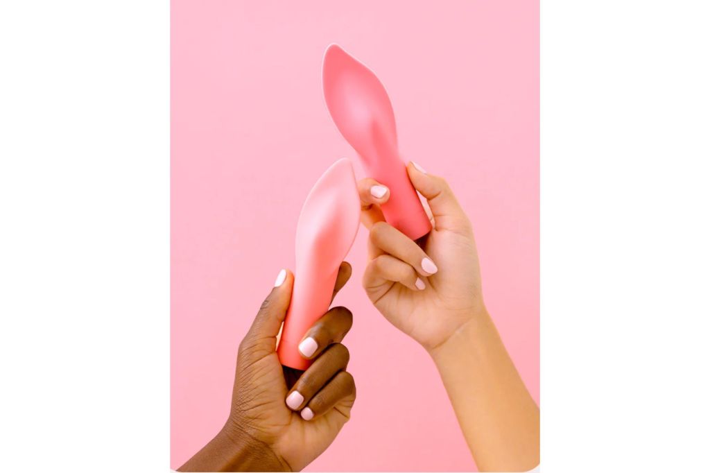 Two hands holding fire shaped vibrators.