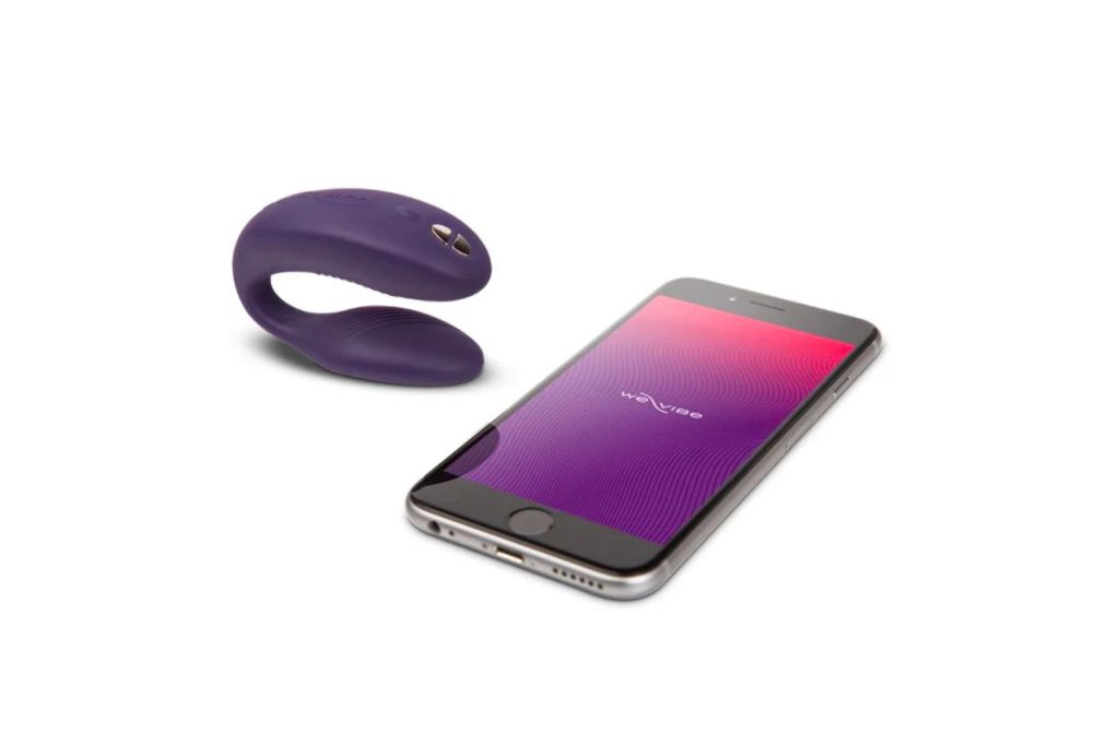 A phone next to a vibrator toy.