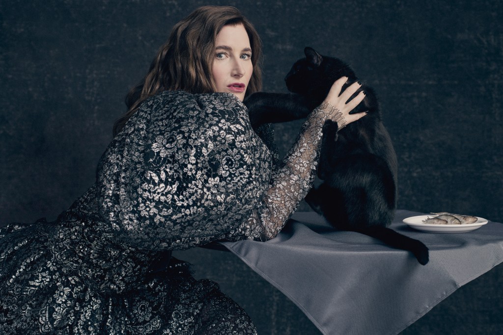 Kathryn Hahn in a dress holding a cat.