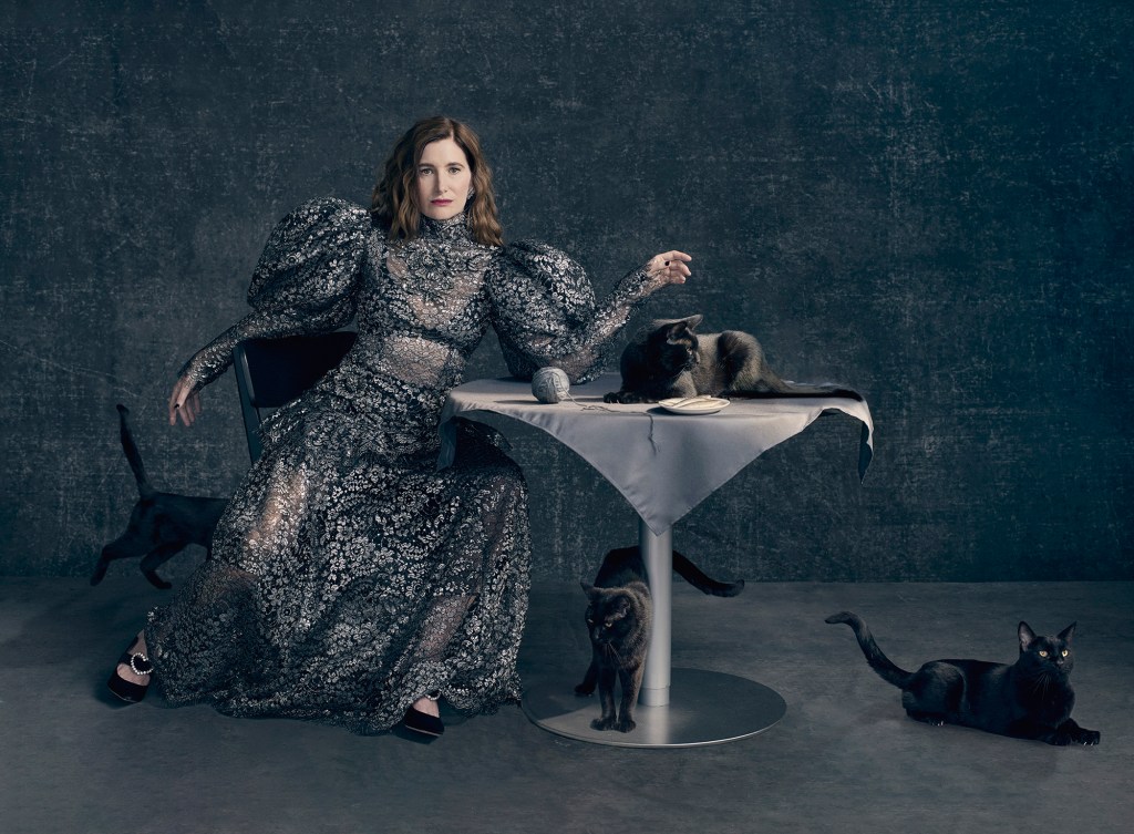 Kathryn Hahn sitting with 4 cats surrounding her.