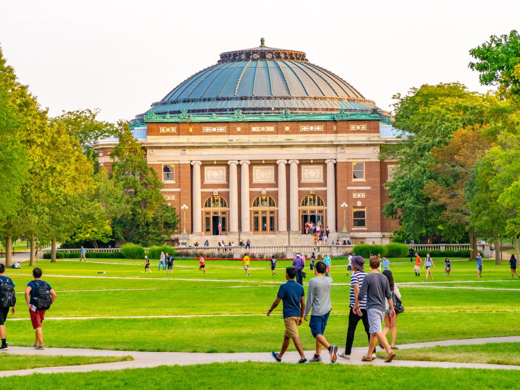 College students walking on the quad lawn of the University of Illinois campus in Urbana, Illinois