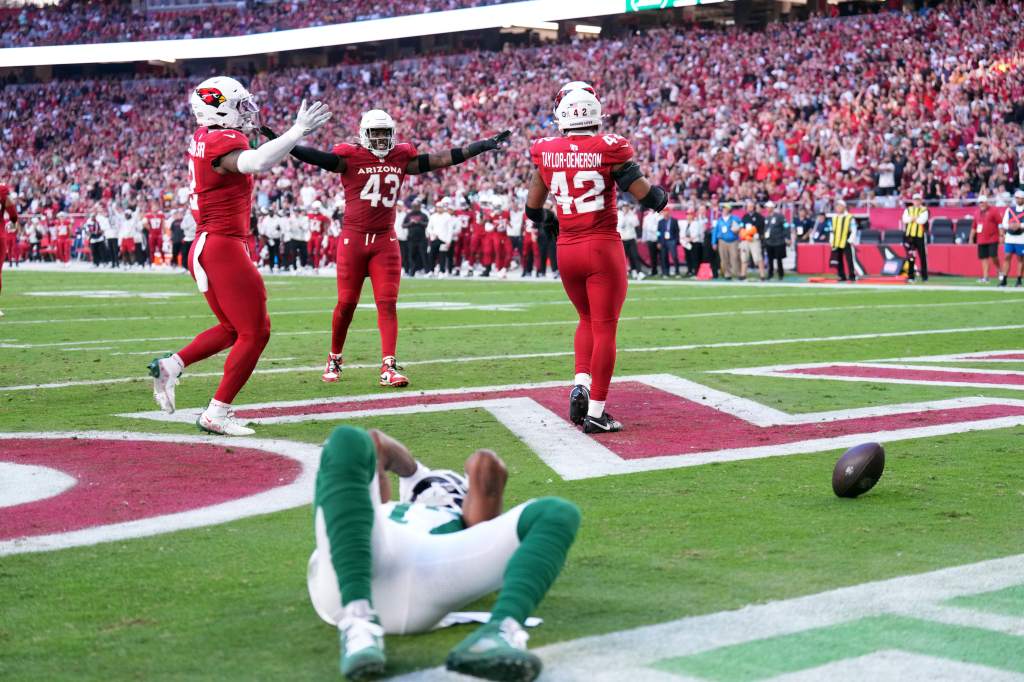 The Cardinals' Mack Wilson Sr. (2), Jesse Luketa (43) and safety Dadrion Taylor-Demerson (42) celebrate an incomplete pass to Jets wide receiver Davante Adams (17) during the second half at State Farm Stadium