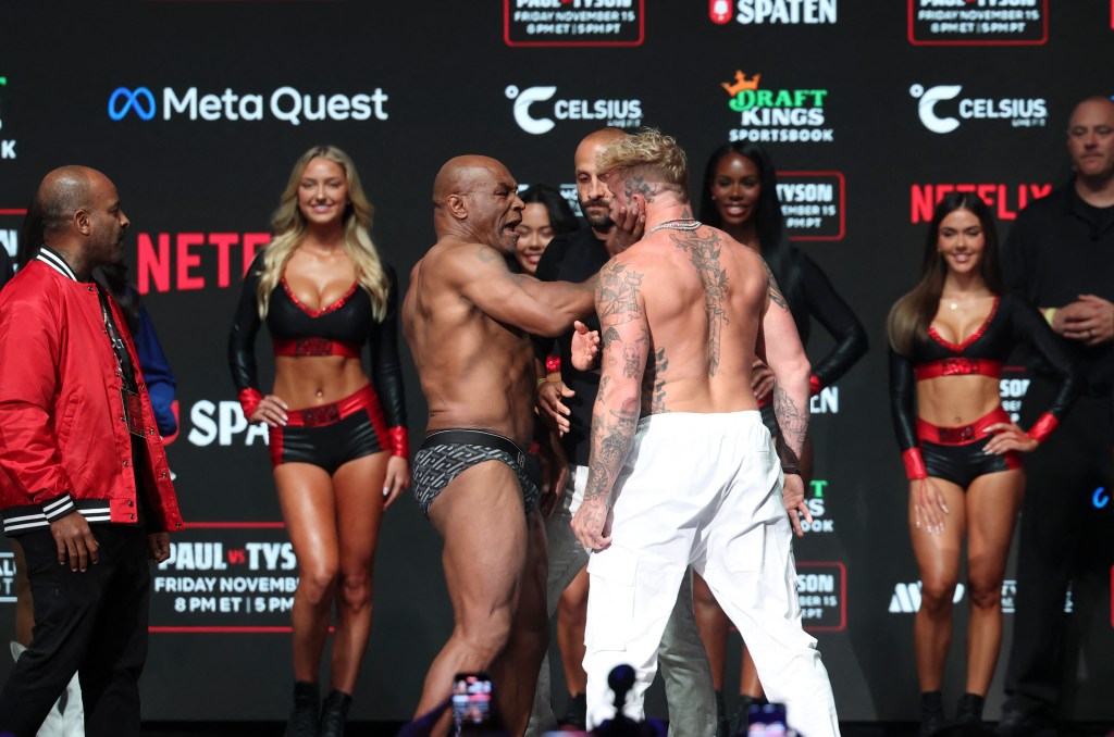 Mike Tyson (left) slaps Jake Paul (right) after weighing in at the Toyota Music Factory.