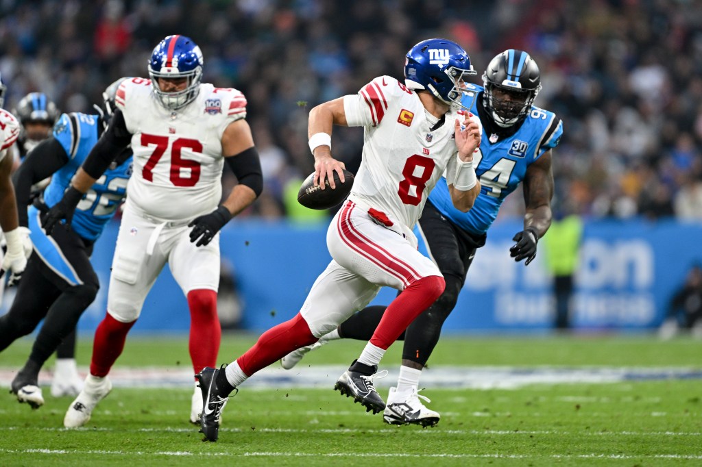 Giants quarterback Daniel Jones runs against the Carolina Panthers during the first half of an NFL football game, Sunday, Nov. 10, 2024, in Munich, Germany.