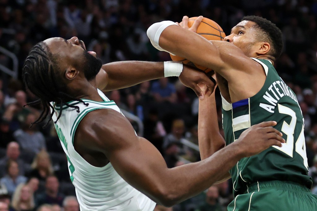 Bucks center Giannis Antetokounmpo elbows Jaylen Brown #7 of the Boston Celtics during a game at Fiserv Forum on November 10, 2024 in Milwaukee, Wisconsin.  