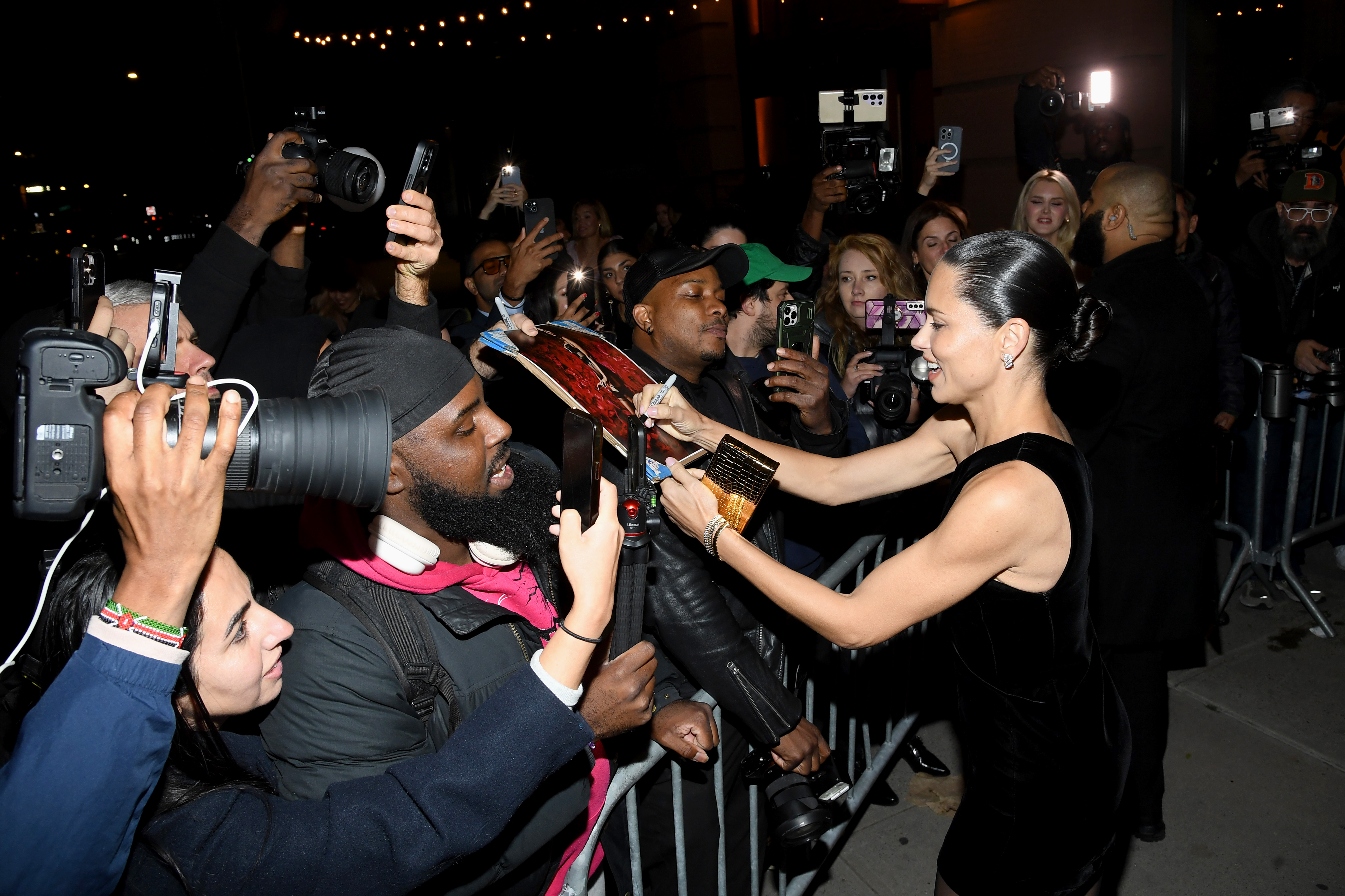 Adriana Lima signs autographs outside of the Victoria's Secret Fashion Show 2024 After Party at Crane Club on October 15, 2024 in New York City. 