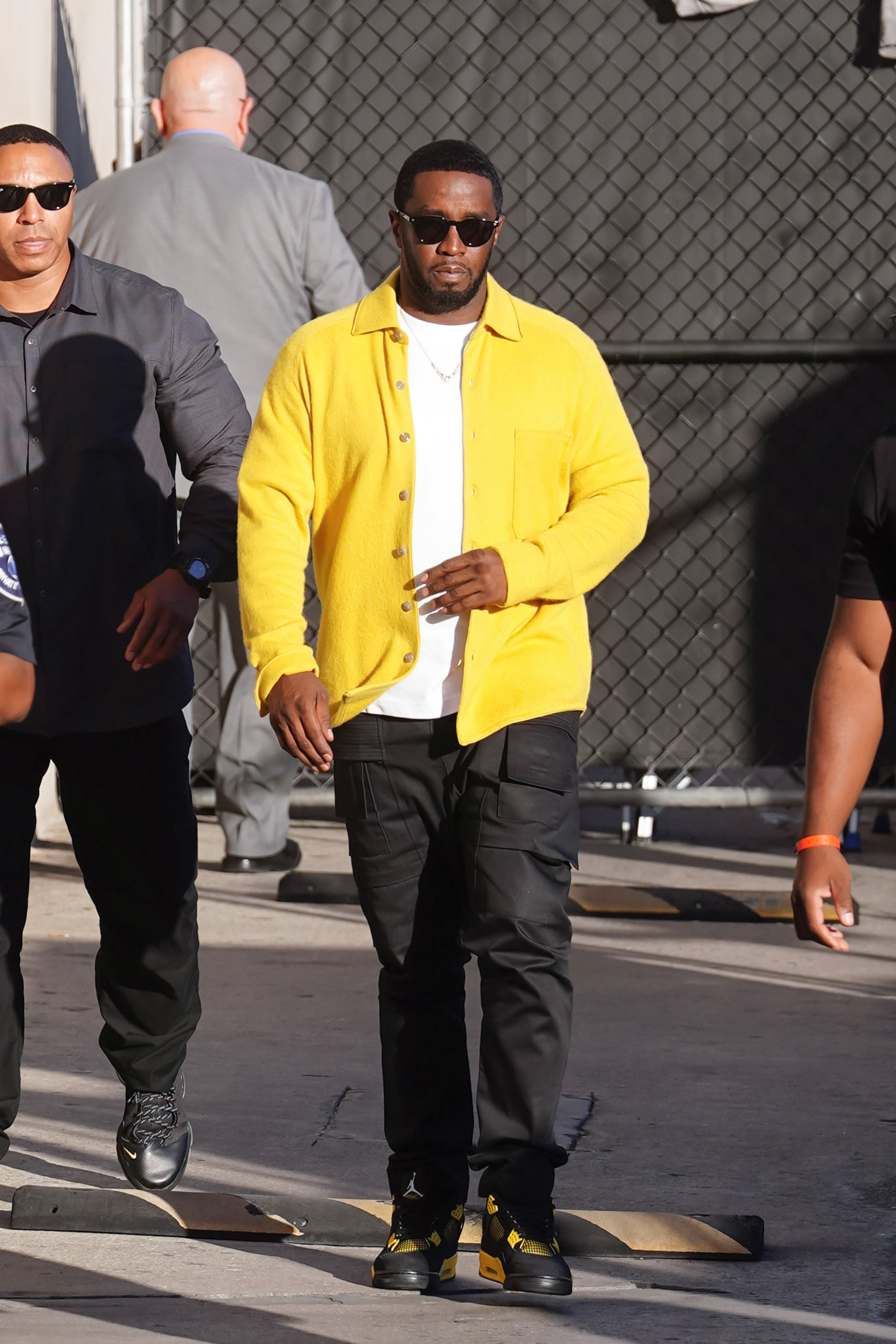 Sean Combs in a yellow jacket. 