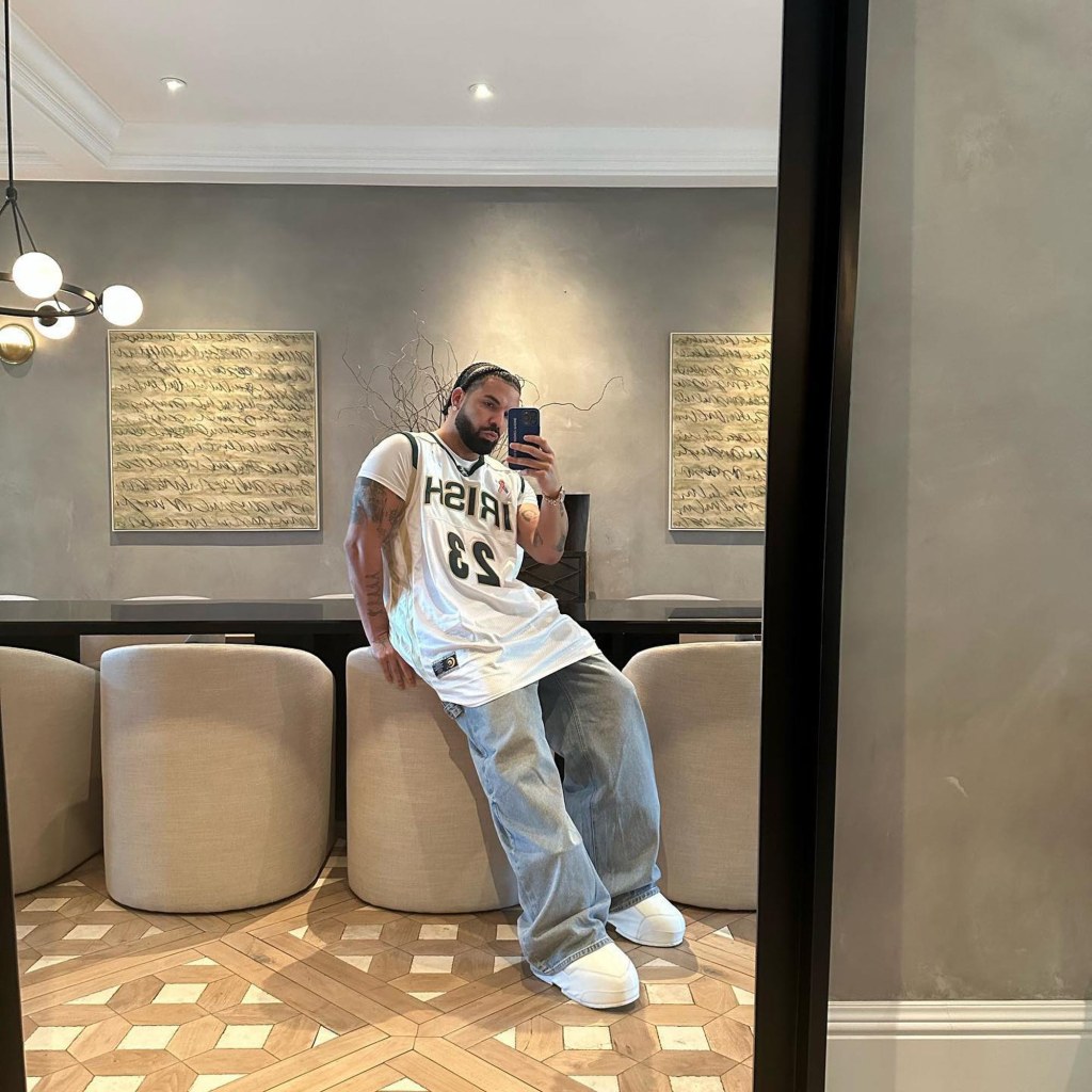 Drake poses in a mirror selfie.