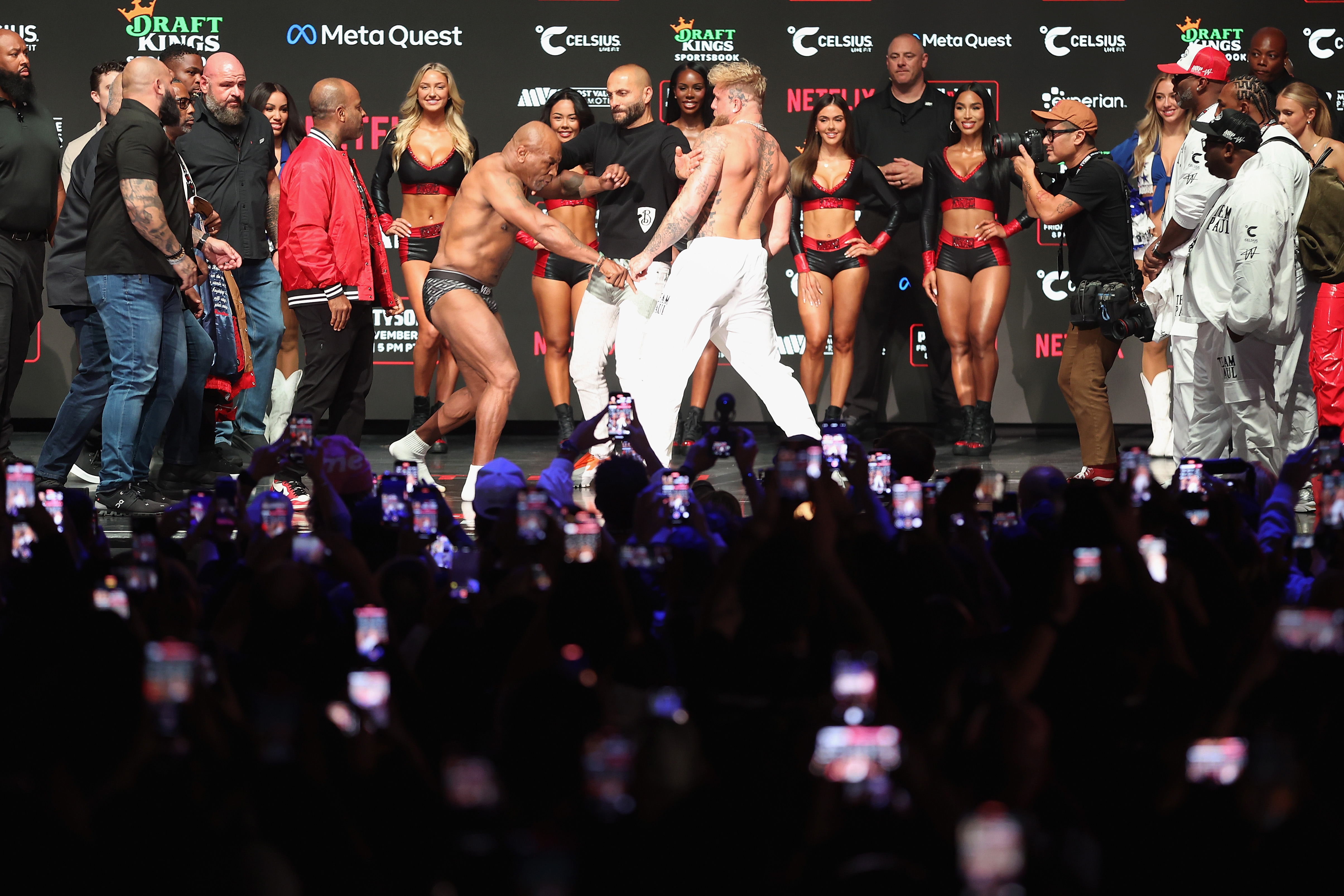 Mike Tyson and Jake Paul facing off at the weigh-in