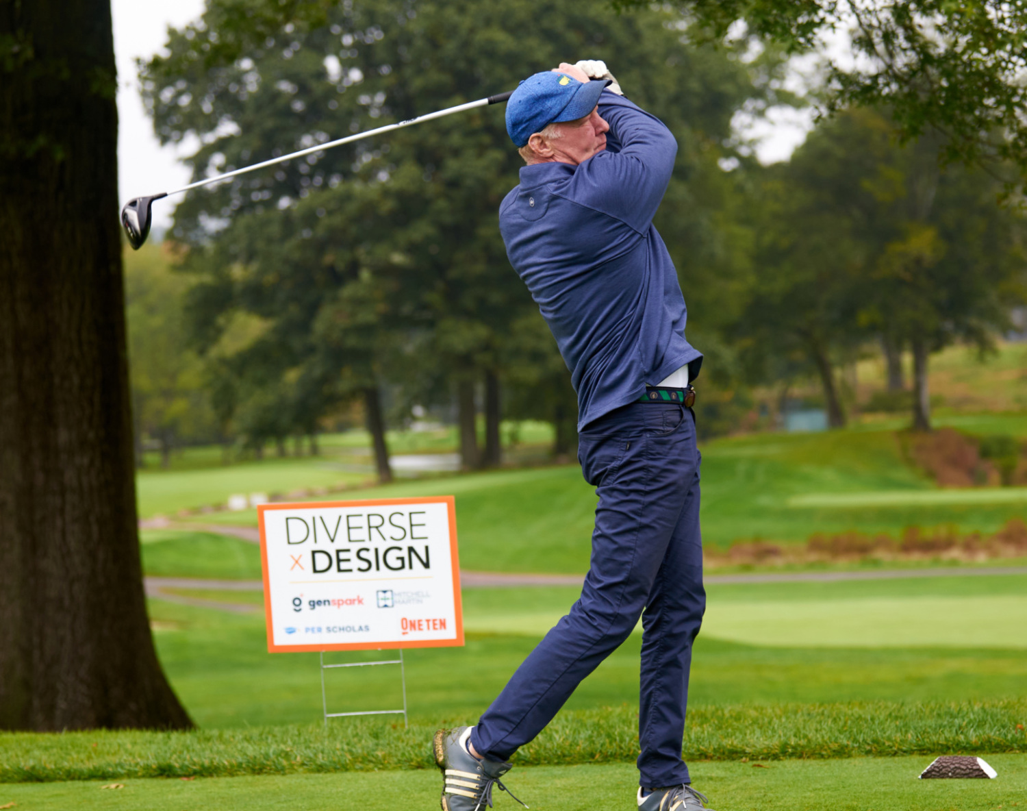 Golfer swinging at the tee box