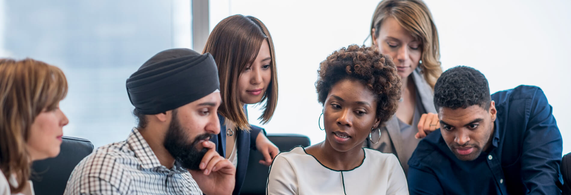 Group of business professionals sitting and standing collaborating together