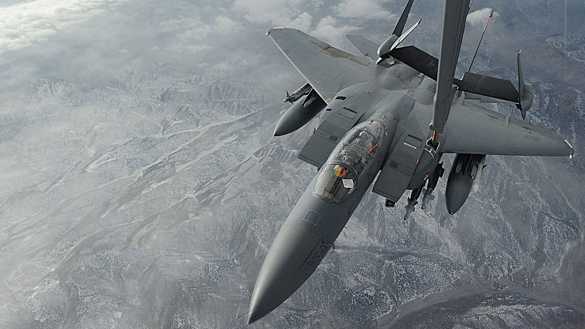 An F-15 StrikeEagle with a refueling arm attached